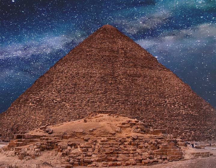 Night sky of the Milky Way over the great pyramids on the platea
